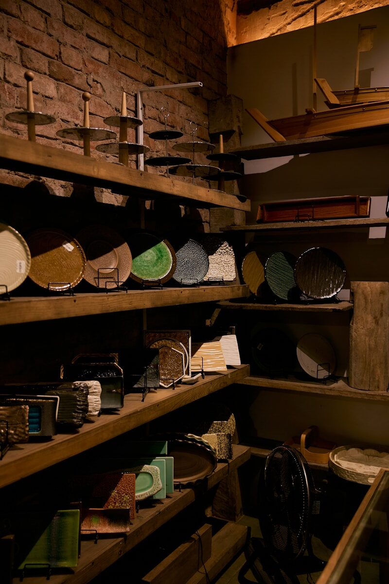 Shelves filled with various plates and pottery items.